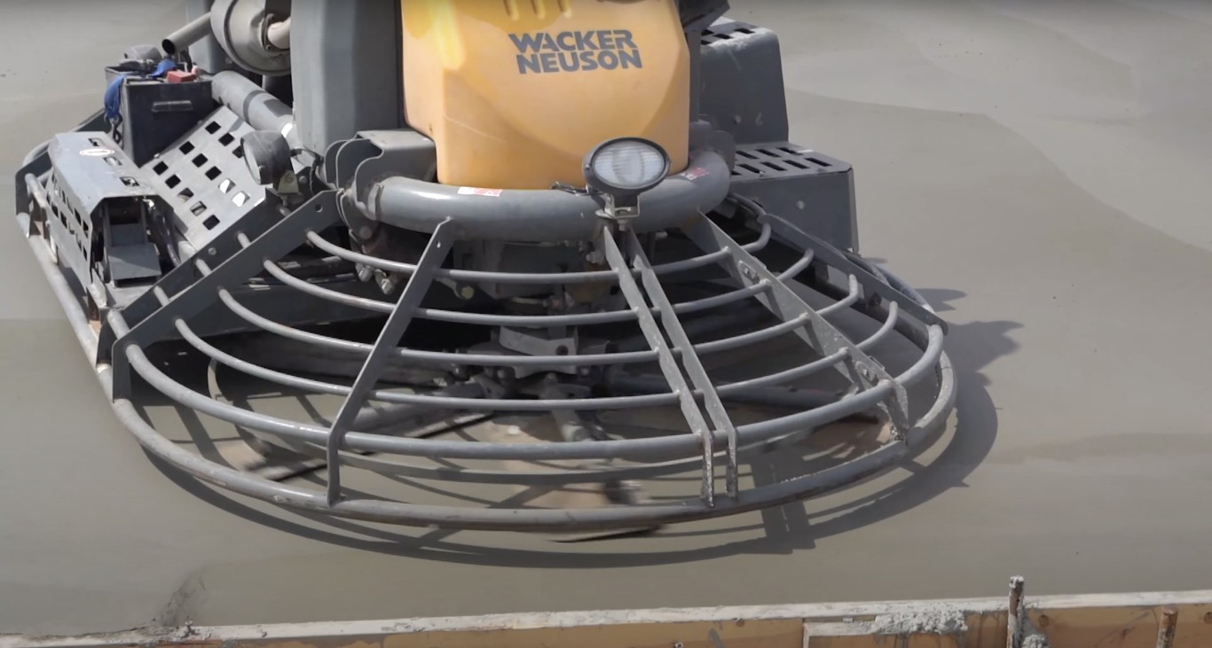Professional concrete finishing with power trowel equipment in McAllen